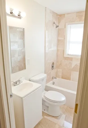 a white toilet sitting next to a bathroom sink