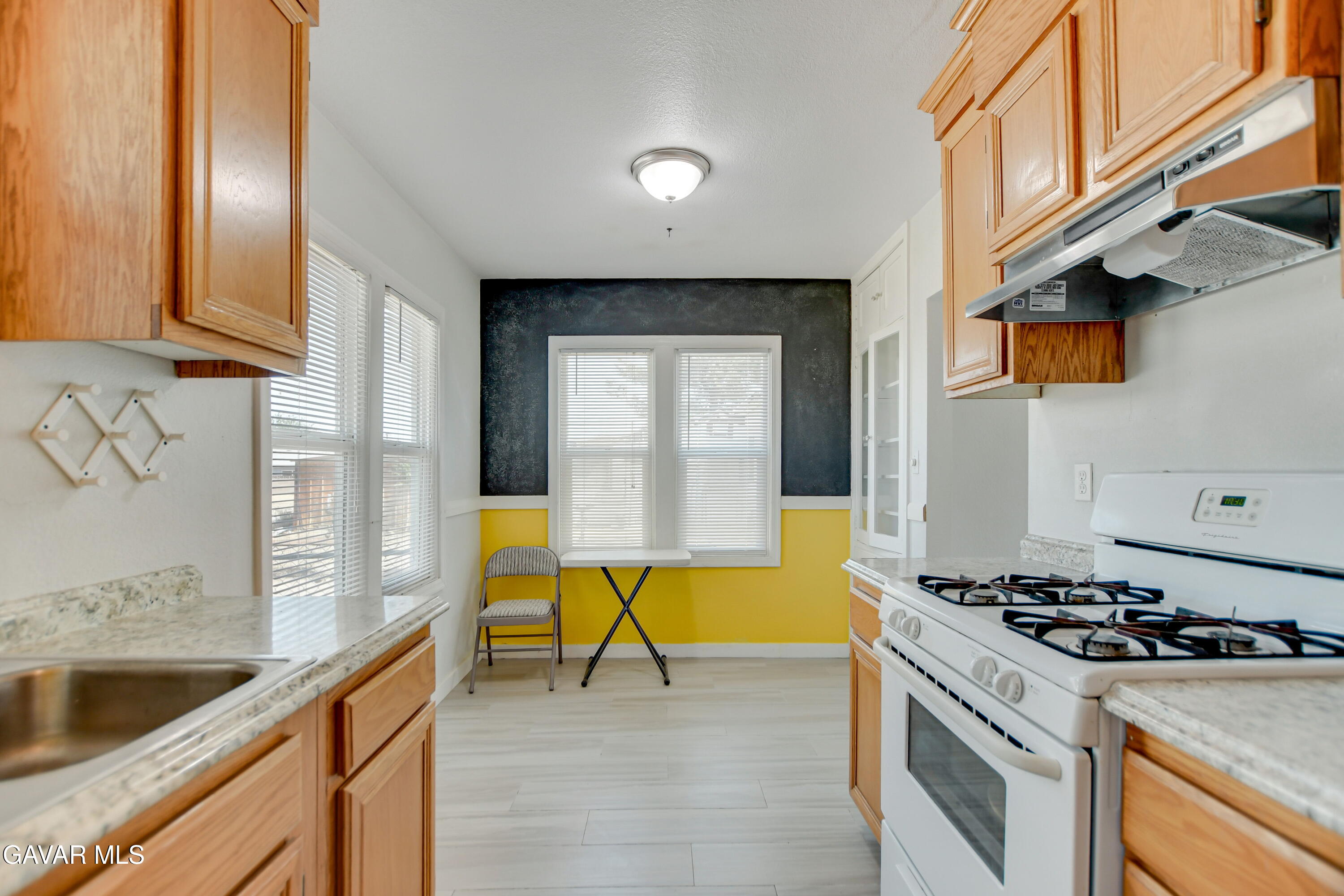 43517 7th Street East Lancaster, CA 93535 - Photo 12 of 47 a kitchen with a stove and a sink