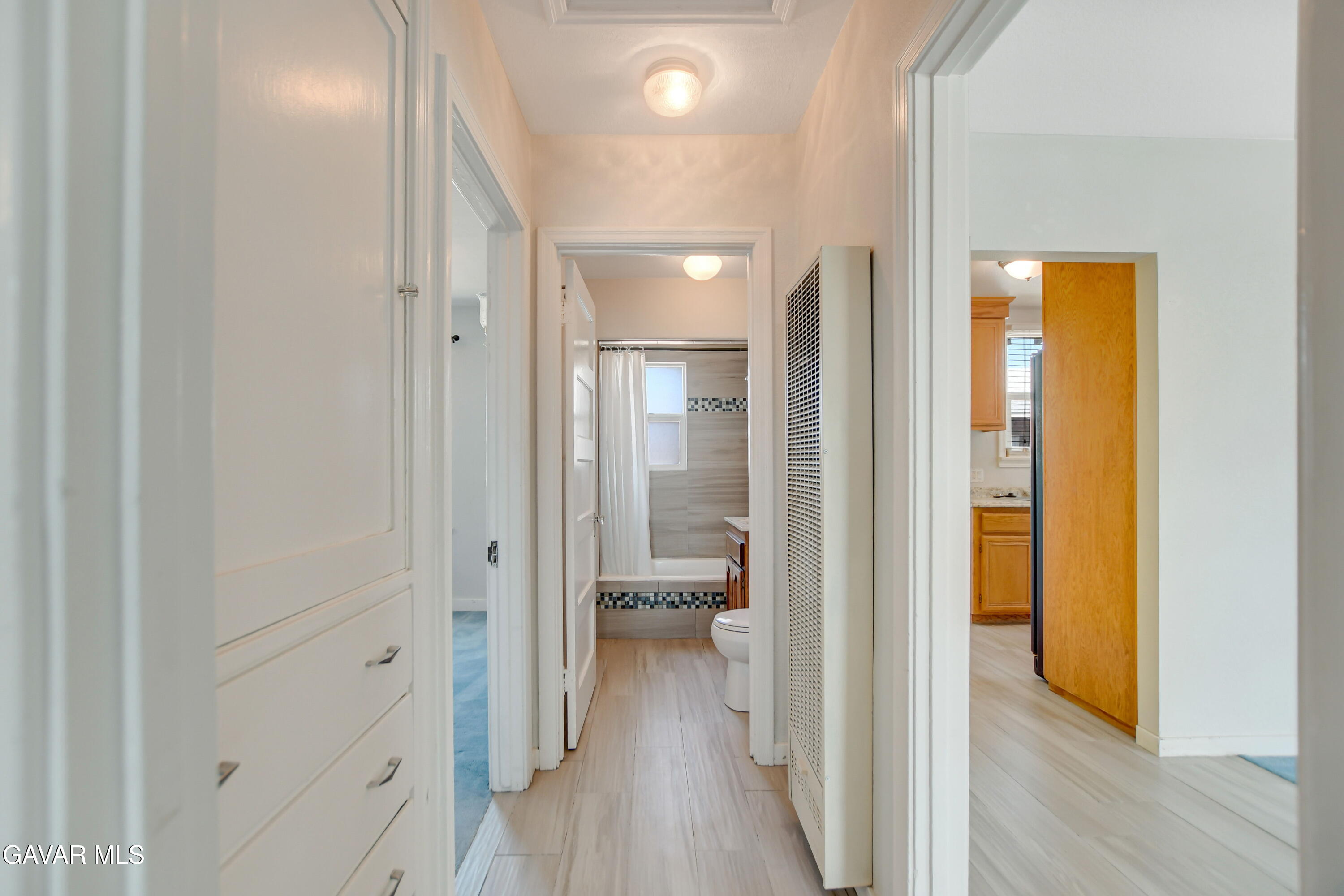 43517 7th Street East Lancaster, CA 93535 - Photo 17 of 47 a view of a hallway with bathroom and wooden floor