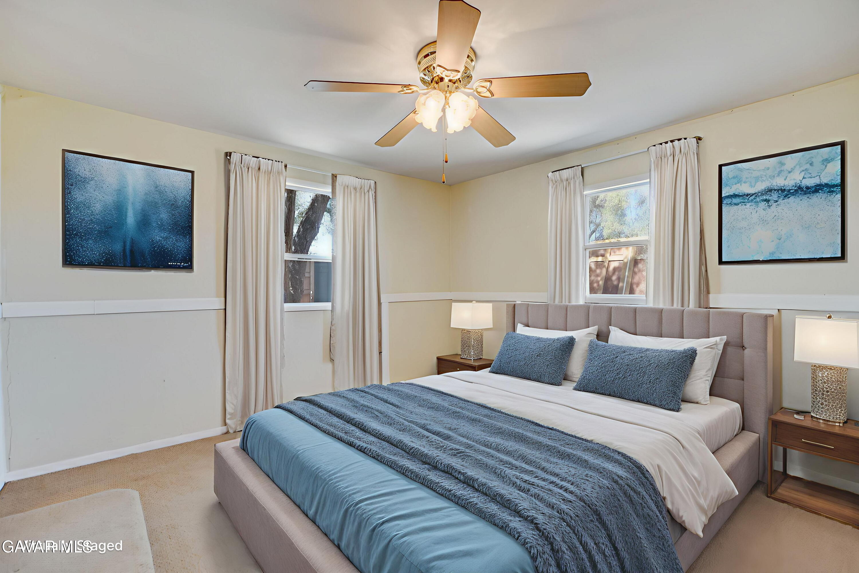 43517 7th Street East Lancaster, CA 93535 - Photo 35 of 47 a bedroom with a large bed and a chandelier