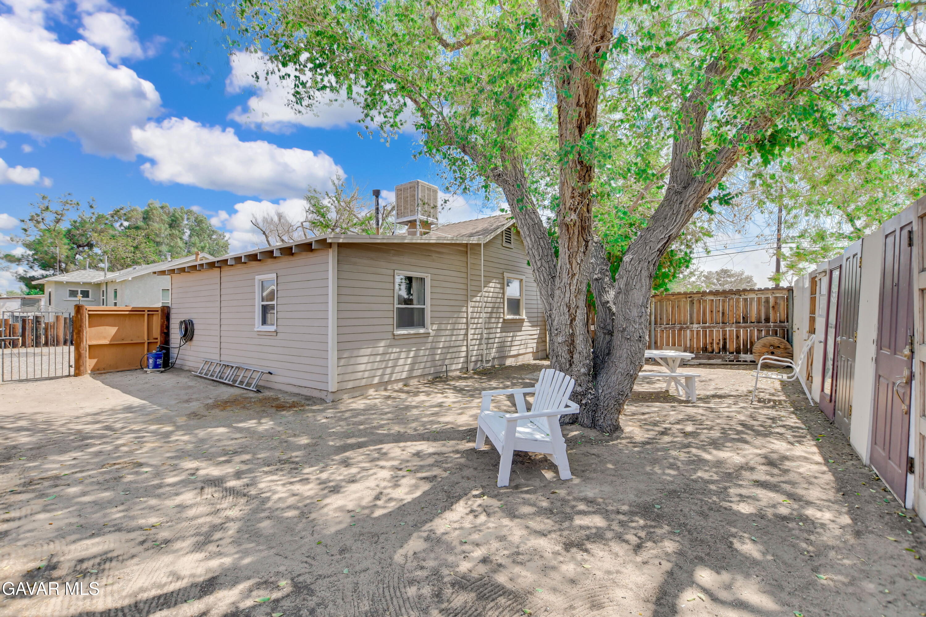 43517 7th Street East Lancaster, CA 93535 - Photo 44 of 47 a view of a chair and table in backyard of the house