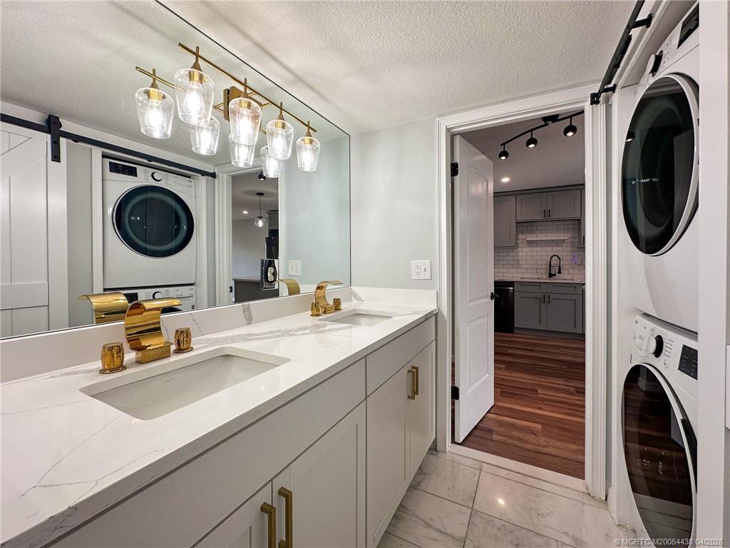 800 Northwest Fork Road, Unit 107 Stuart, FL 34994 - Photo 6 of 21 a bathroom with a sink a washer and dryer