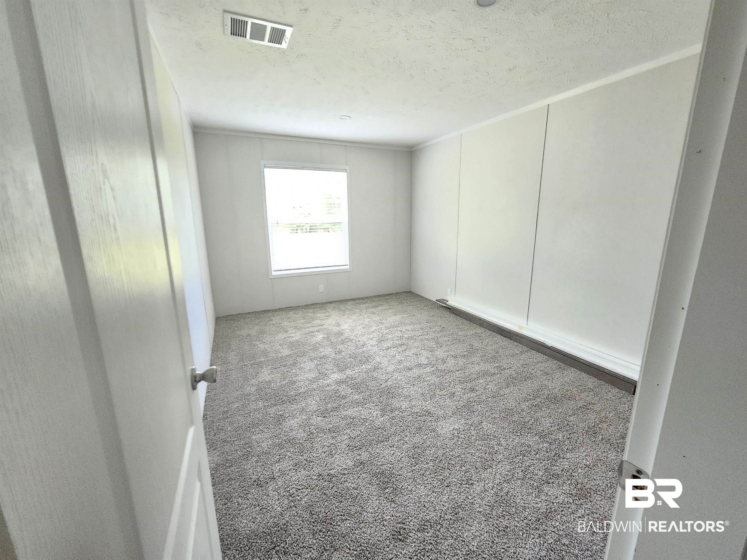 1863 Wait Road Monroeville, AL 36460 - Photo 21 of 38 Carpeted spare room featuring a textured ceiling