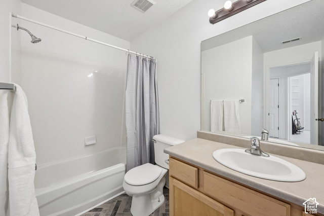 3863 East Cascade Road, Unit 3 Eagle Mountain, UT 84005 - Photo 21 of 37 Bathroom featuring a shower-tub combination, vanity with an integrated sink, broad wall mirror, and wood-finish flooring