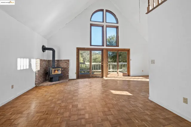a view of an empty room with a fireplace