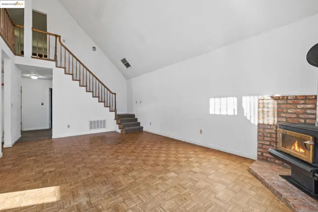a view of an empty room and fire place