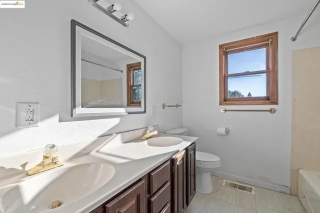 a bathroom with a sink vanity and toilet