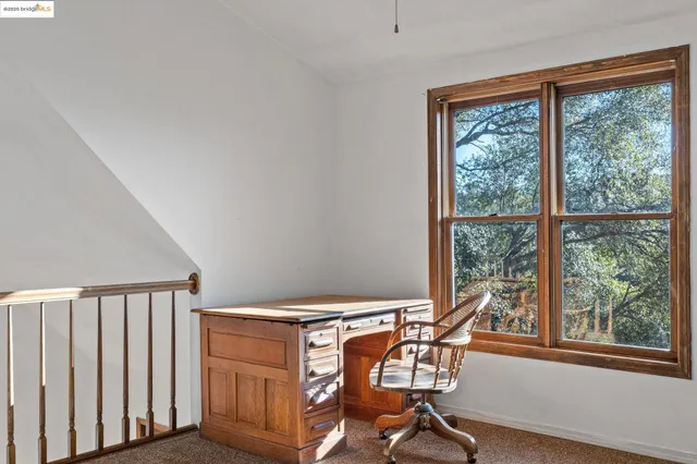 a view of a room with a table and chairs