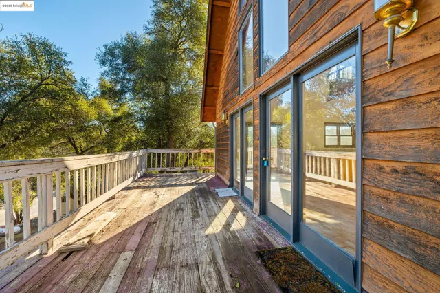 a view of balcony with wooden floor and fence