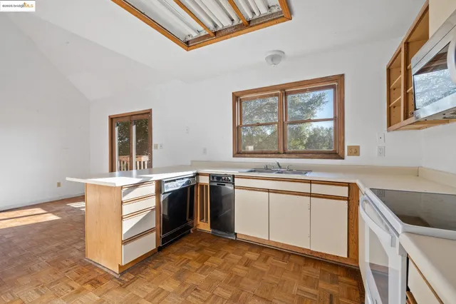 a kitchen with stainless steel appliances kitchen island a sink stove and microwave