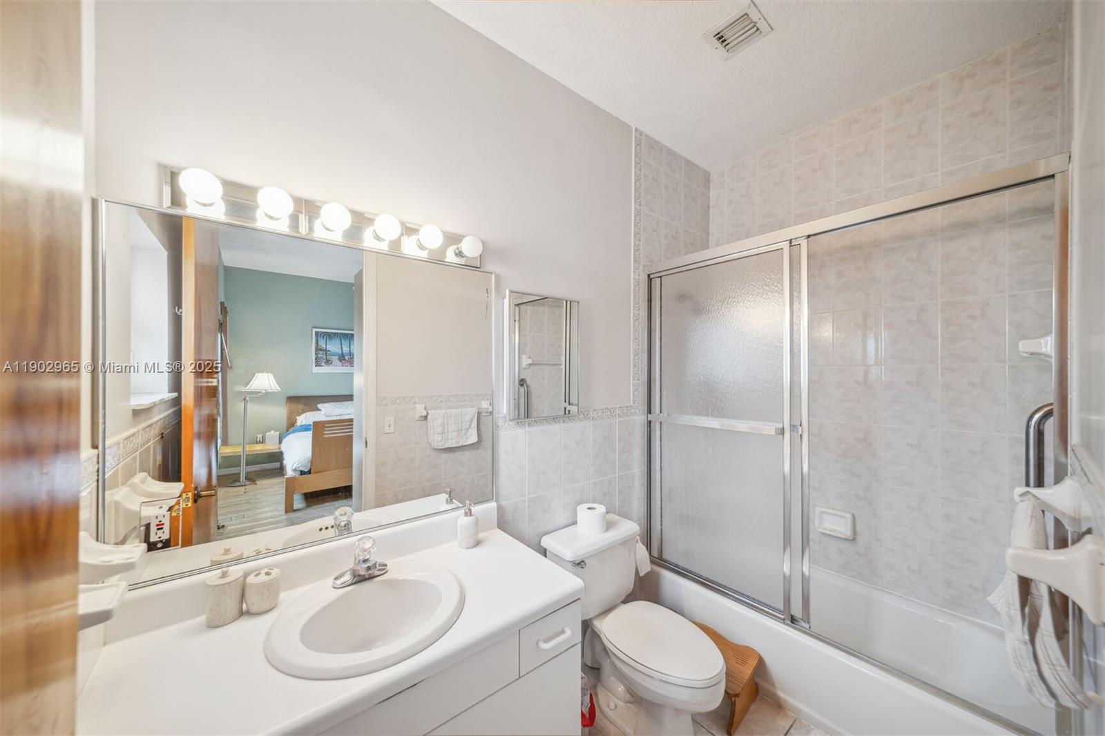 9008 Collins Avenue, Unit 402 Surfside, FL 33154 - Photo 22 of 65 a bathroom with a sink toilet tub and shower