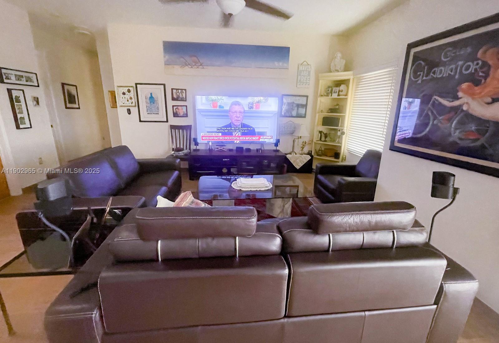 9008 Collins Avenue, Unit 402 Surfside, FL 33154 - Photo 52 of 65 a living room with furniture and a couch