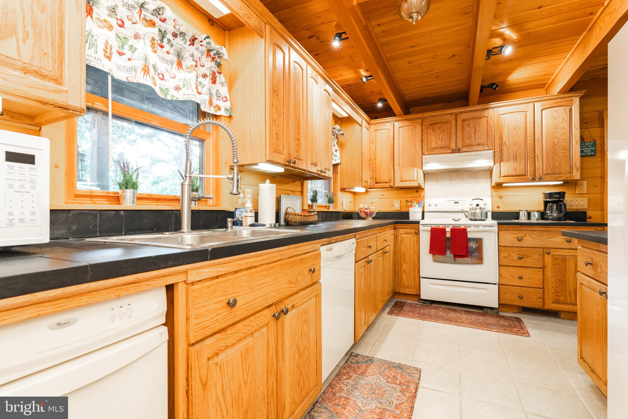 82 Sabrina Lane Gerrardstown, WV 25420 - Photo 36 of 104 a open kitchen with granite countertop a stove a sink and white cabinets