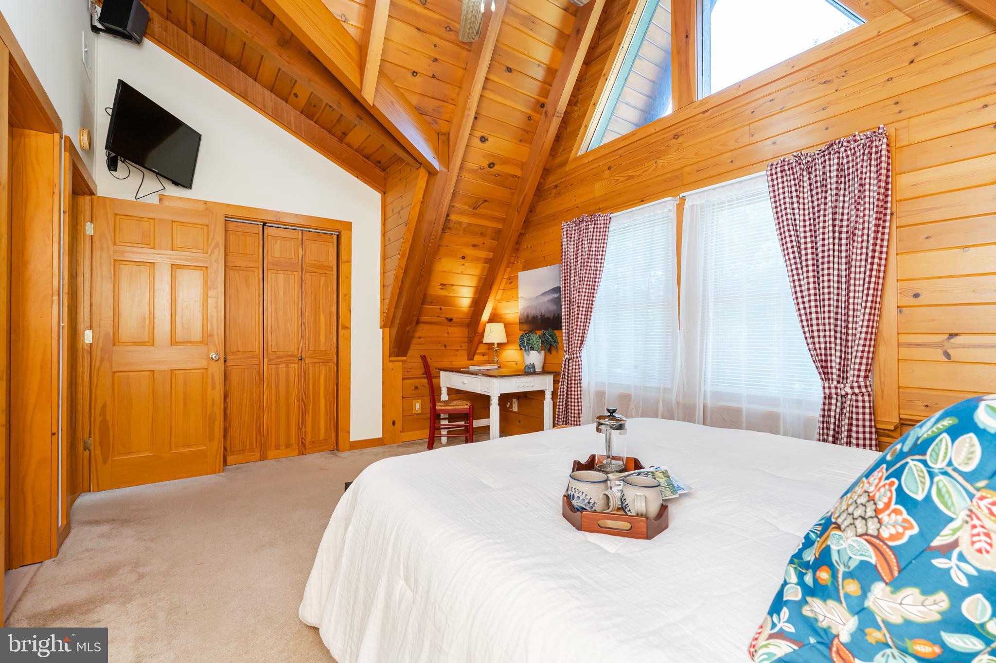 82 Sabrina Lane Gerrardstown, WV 25420 - Photo 74 of 104 a bedroom with a bed and a chandelier