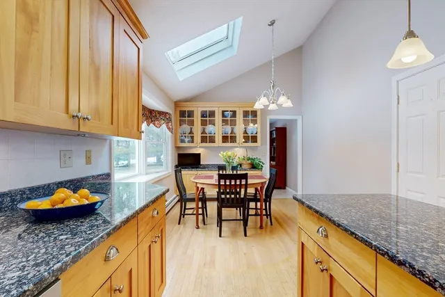 a dining room with furniture and a floor to ceiling window