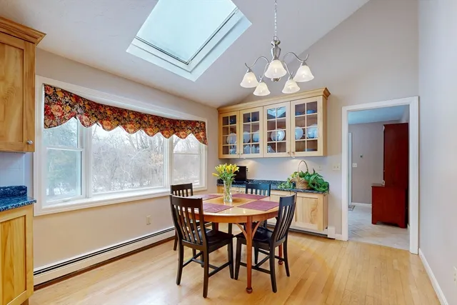 a view of a dining room with furniture a chandelier and wooden floor