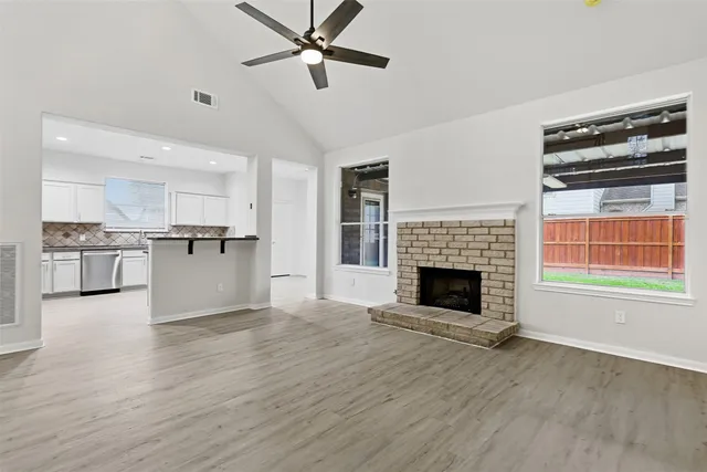 a view of a kitchen with an empty space and a fireplace
