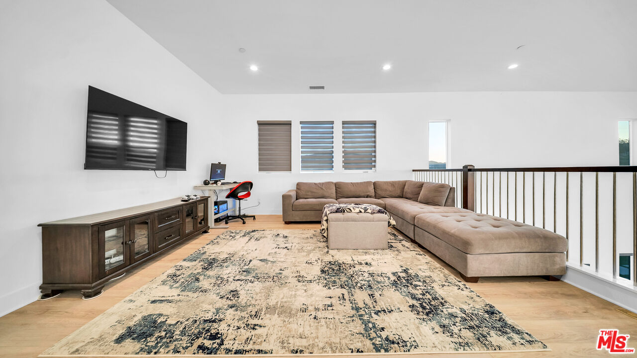 12553 Ridgeline Road Porter Ranch, CA 91326 - Photo 20 of 45 a living room with furniture window and a flat screen tv