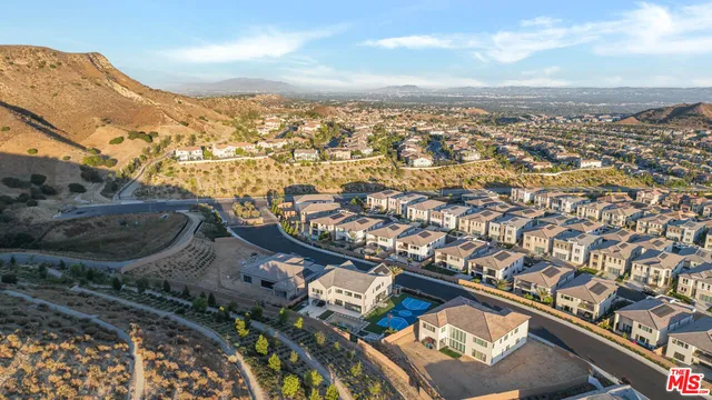 an aerial view of residential building and car parked