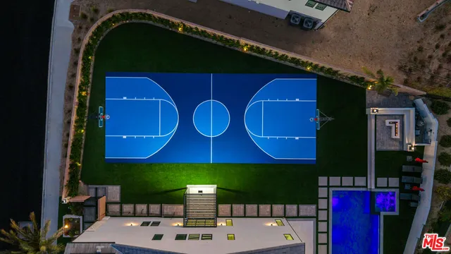 a large white kitchen with a large window and stainless steel appliances