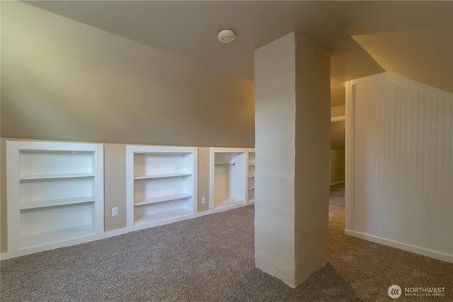 a view of an empty room with a closet