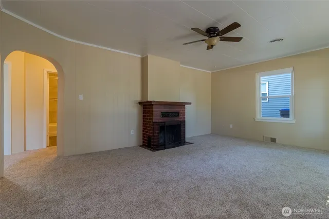 a view of an empty room with a fireplace