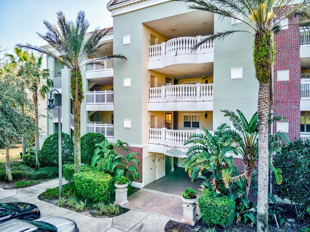 1114 Sunset View Circle, Unit 302 Reunion, FL 34747 - Photo 1 of 1 a front view of multi story residential apartment building with yard and seating area