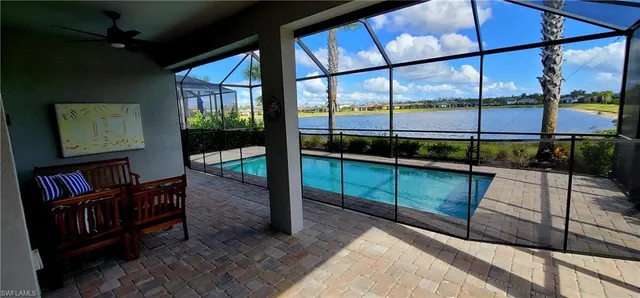 a view of a patio with table and chairs potted plants and palm tree