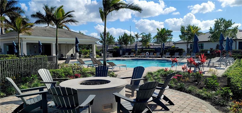 2045 Yellowfin Circle Naples, FL 34114 - Photo 22 of 23 a view of a patio with table and chairs potted plants and palm tree