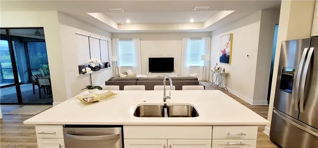 a kitchen with a sink a counter top space and stainless steel appliances