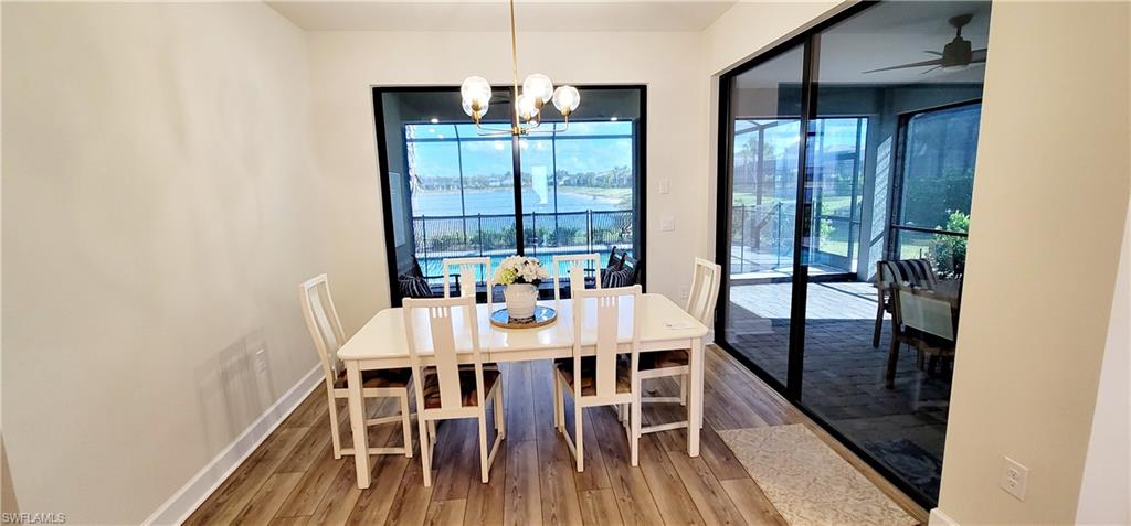 2045 Yellowfin Circle Naples, FL 34114 - Photo 7 of 23 a view of a dining room with furniture window and wooden floor
