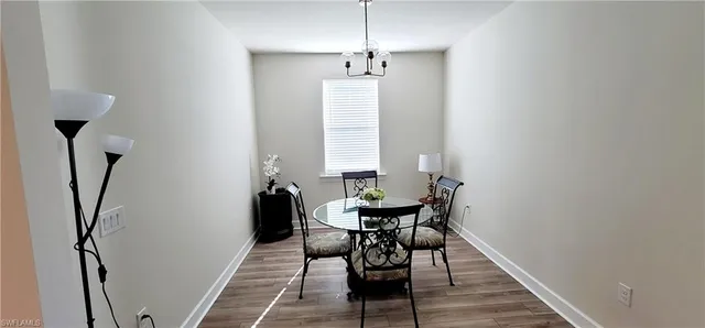 a view of a room with furniture and wooden floor