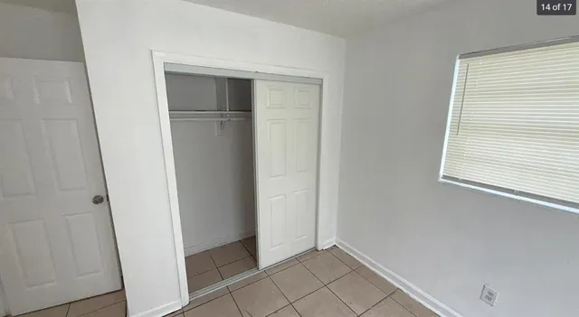 a view of an empty room with closet