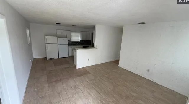 a view of a kitchen with a sink cabinets and a window