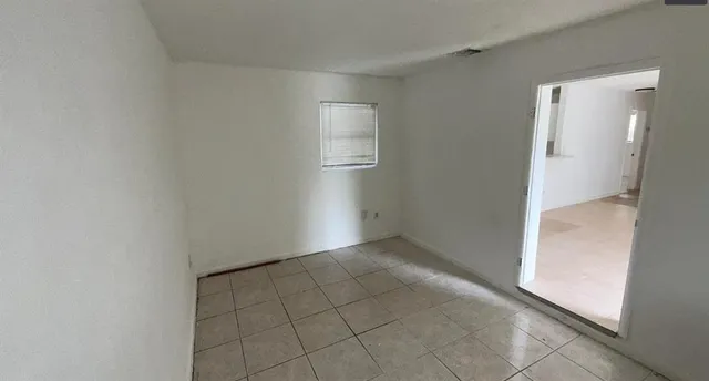 a hallway with cabinets washer and dryer