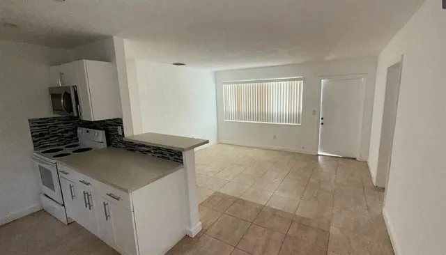 a front view of house with yard and trees around