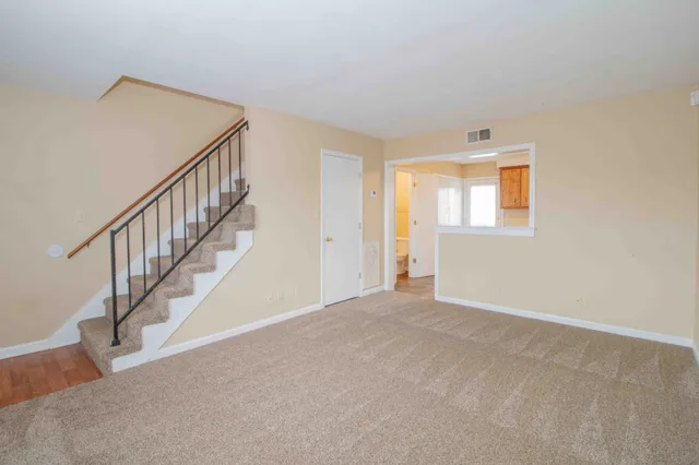 a view of an empty room with stairs
