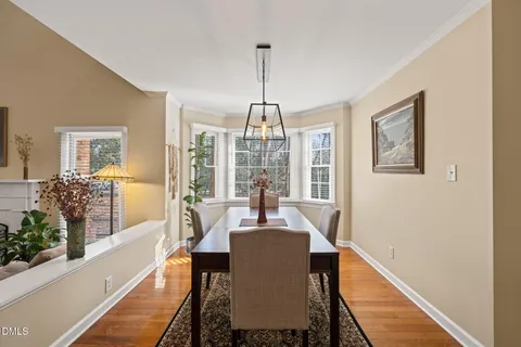 a view of a dining room with furniture wooden floor and a chandelier