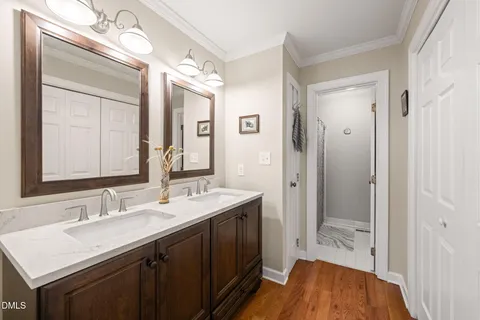 a bedroom with a bed a dresser and chair