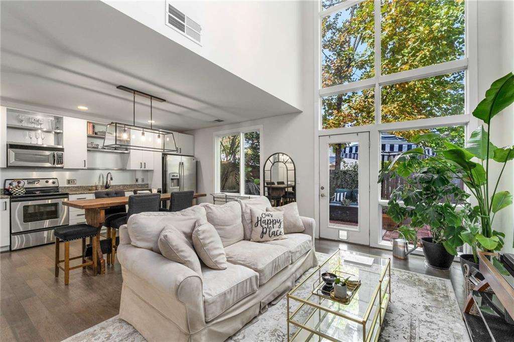 a living room with furniture and a potted plant