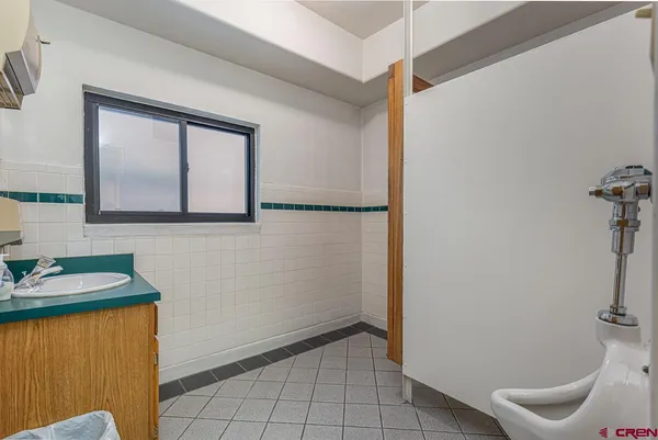 a view of a room that has a sink and a mirror in it