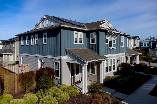 a front view of a house with a garden