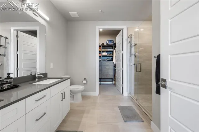 a bathroom with a double vanity sink and a toilet