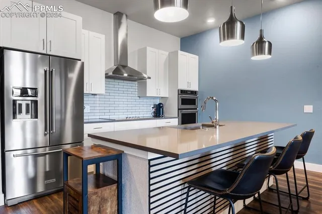 a kitchen with cabinets and steel stainless steel appliances