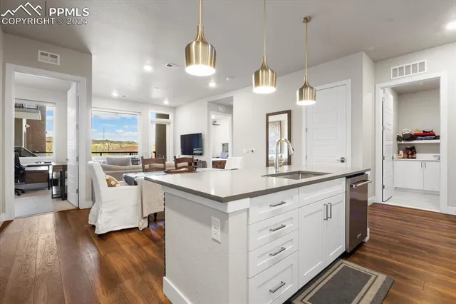 a view of a kitchen with center island and stainless steel appliances