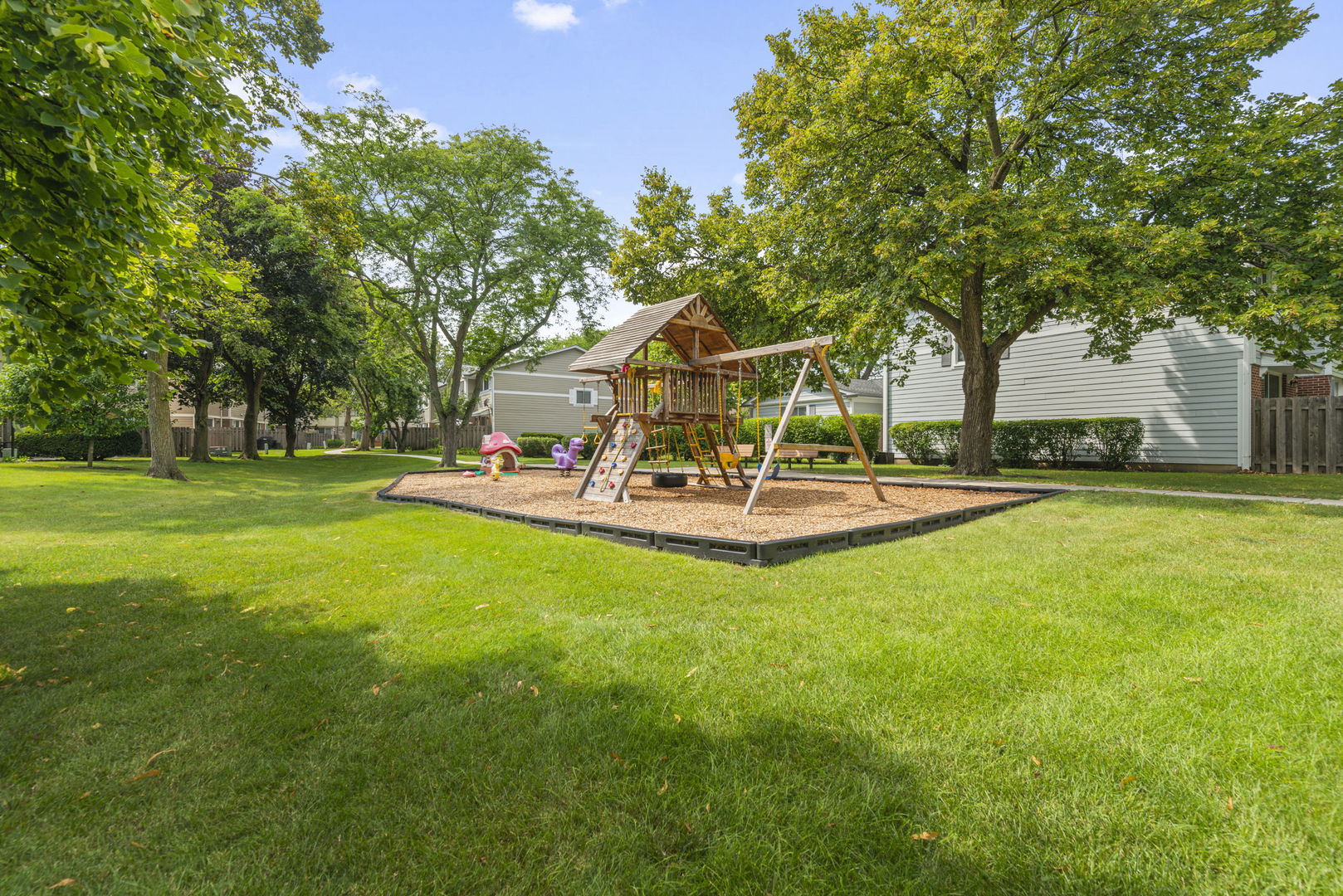 416 Swallow Lane Deerfield, IL 60015 - Photo 23 of 31 a view of a park with swings and a bench