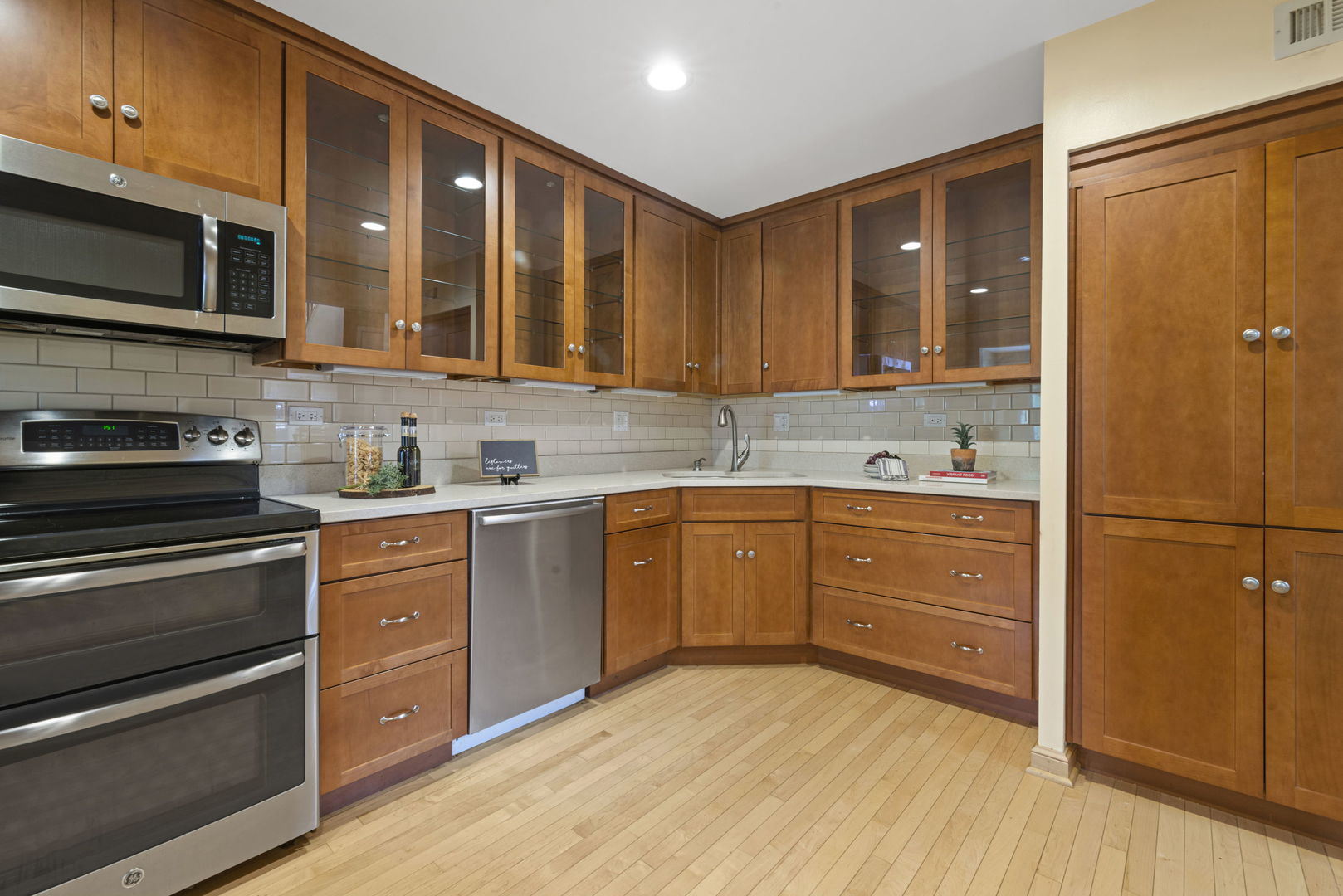 416 Swallow Lane Deerfield, IL 60015 - Photo 7 of 31 a kitchen with stainless steel appliances granite countertop a refrigerator and a stove top oven