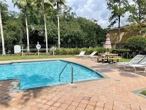 a view of a swimming pool with a lounge chairs