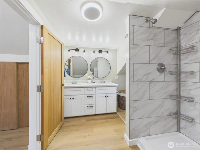 a bathroom with a granite countertop sink and a mirror