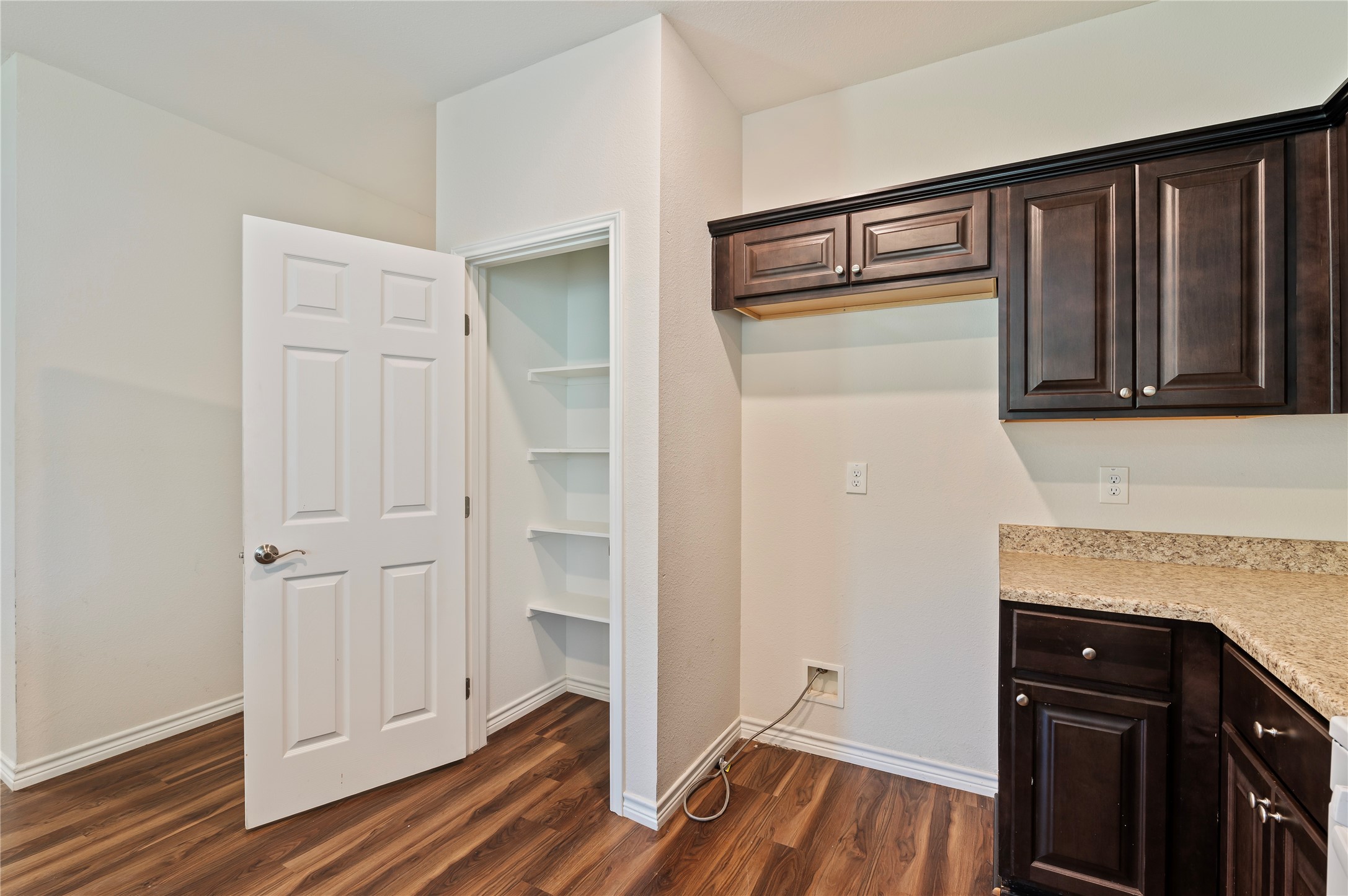 1125 Lake Road La Marque, TX 77568 - Photo 12 of 33 a view of walk in closet with wooden floor and cabinets